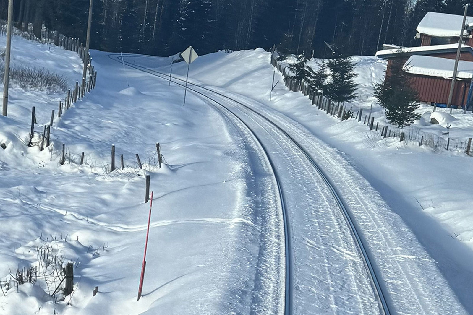 Tydelige skispor på begge sider av sporet, som ligger i en kurve.